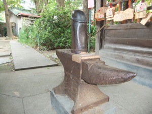 An anvil with a giant penis on top