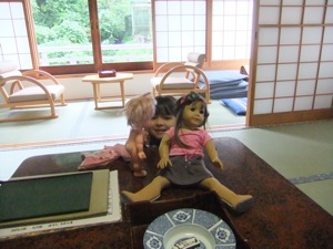 真由喜が人形の後ろから覗いて見ている